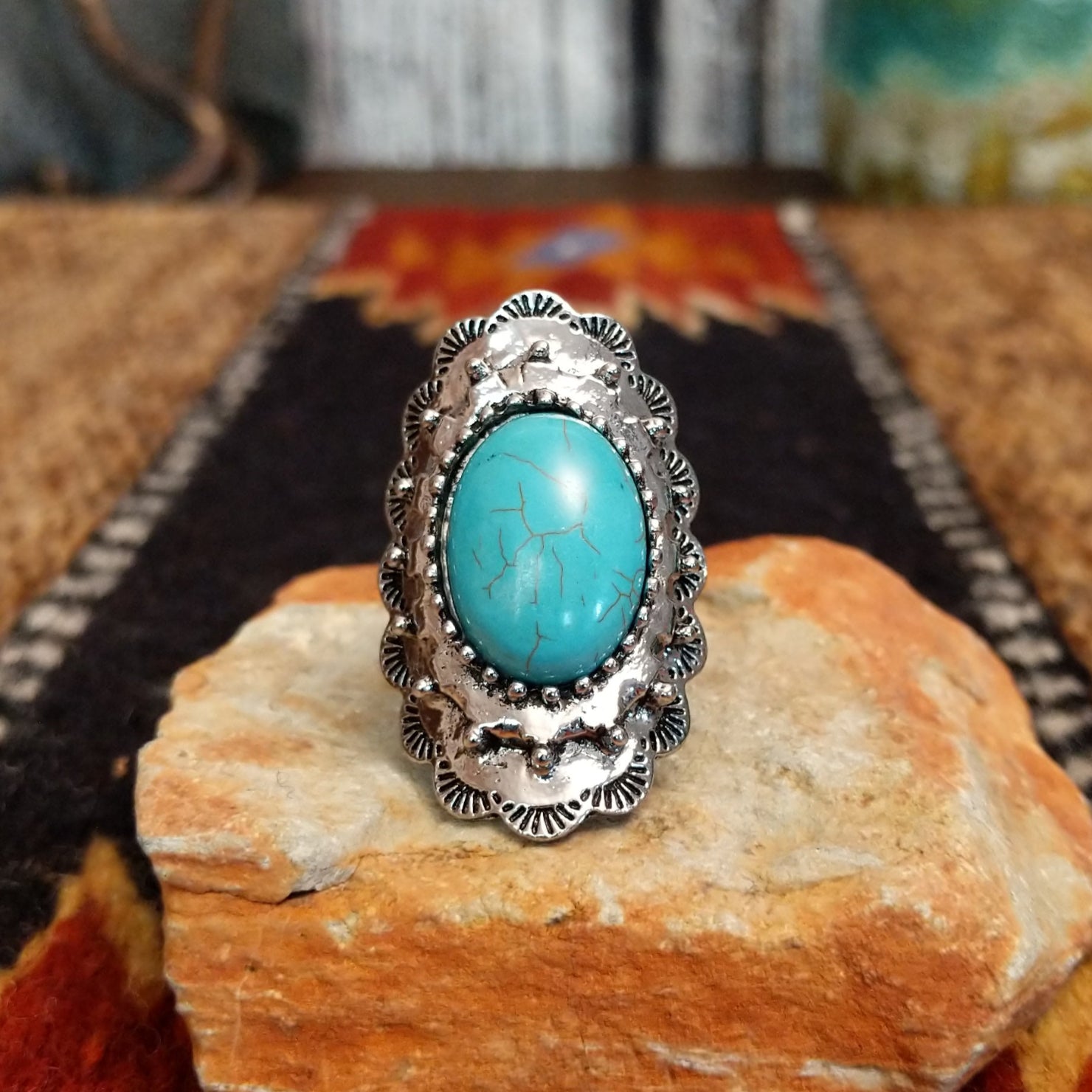 Nickel-free metal ring with a turquoise stone and ornate scalloped edge.