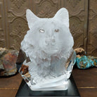 A clear Lucite sculpture featuring two hand-painted wolves with a frosted wolf's face emerging in the background, symbolizing loyalty and family.