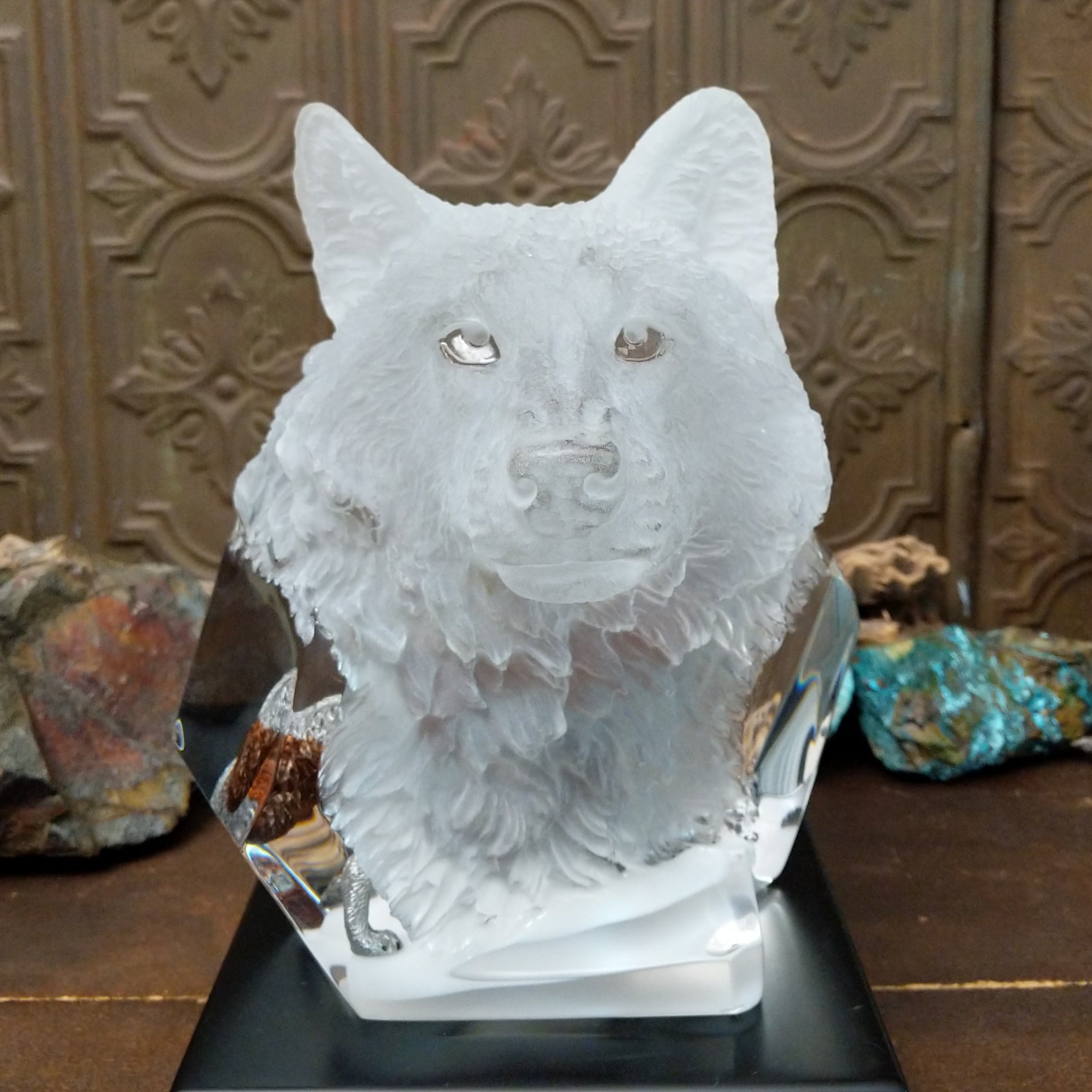 A clear Lucite sculpture featuring two hand-painted wolves with a frosted wolf's face emerging in the background, symbolizing loyalty and family.