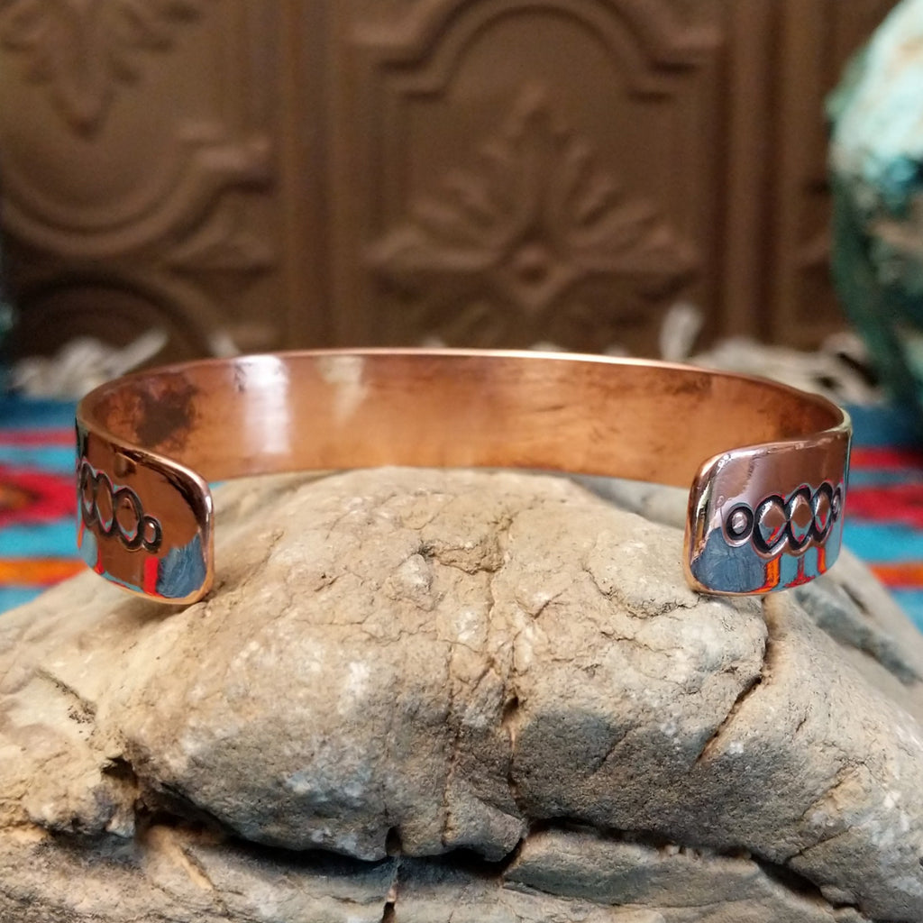 Copper and sterling silver cuff with grass stamping and polished finish.