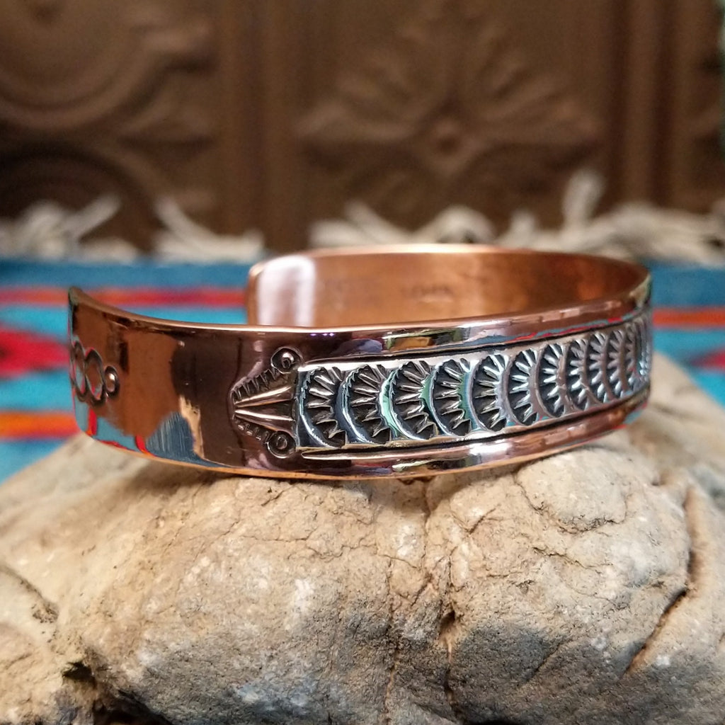 Copper and sterling silver cuff with grass stamping and polished finish.