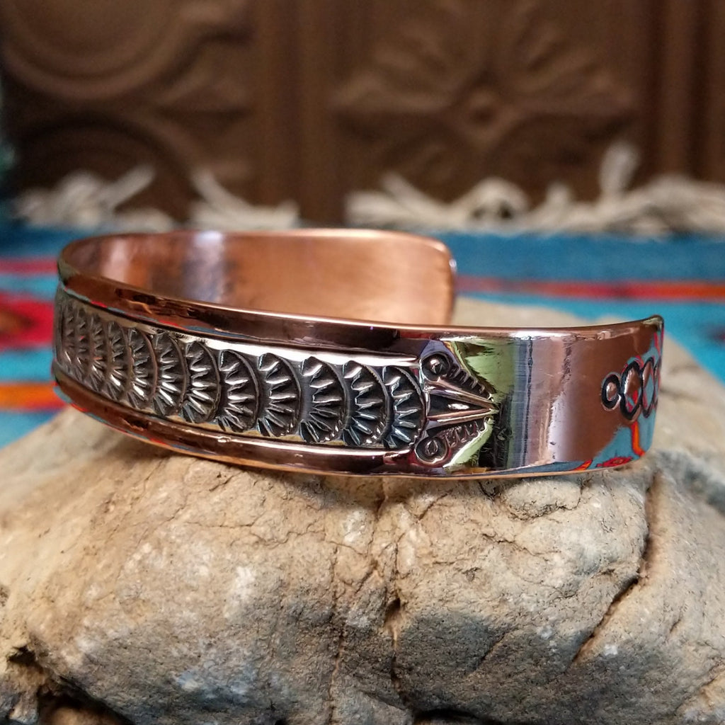 Copper and sterling silver cuff with grass stamping and polished finish.