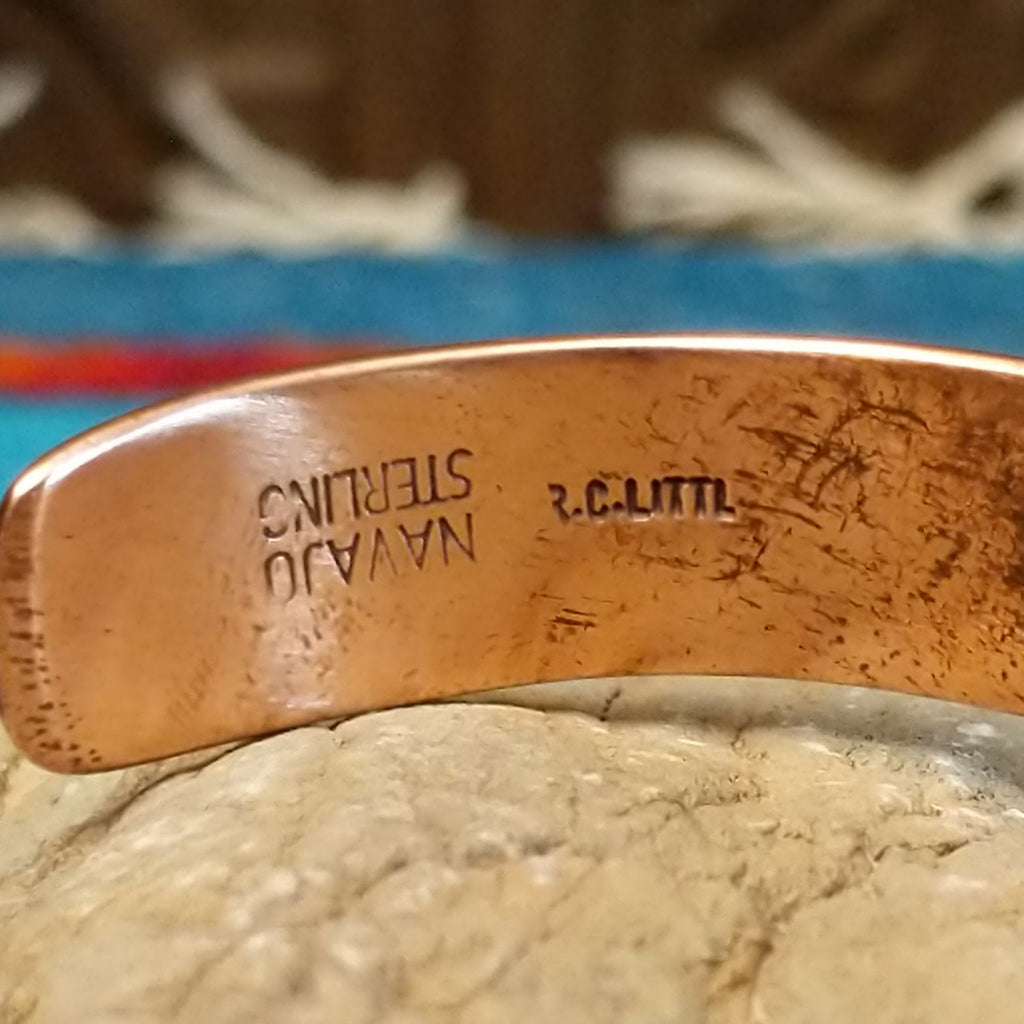 Close-up of the artisan's stamped signature.