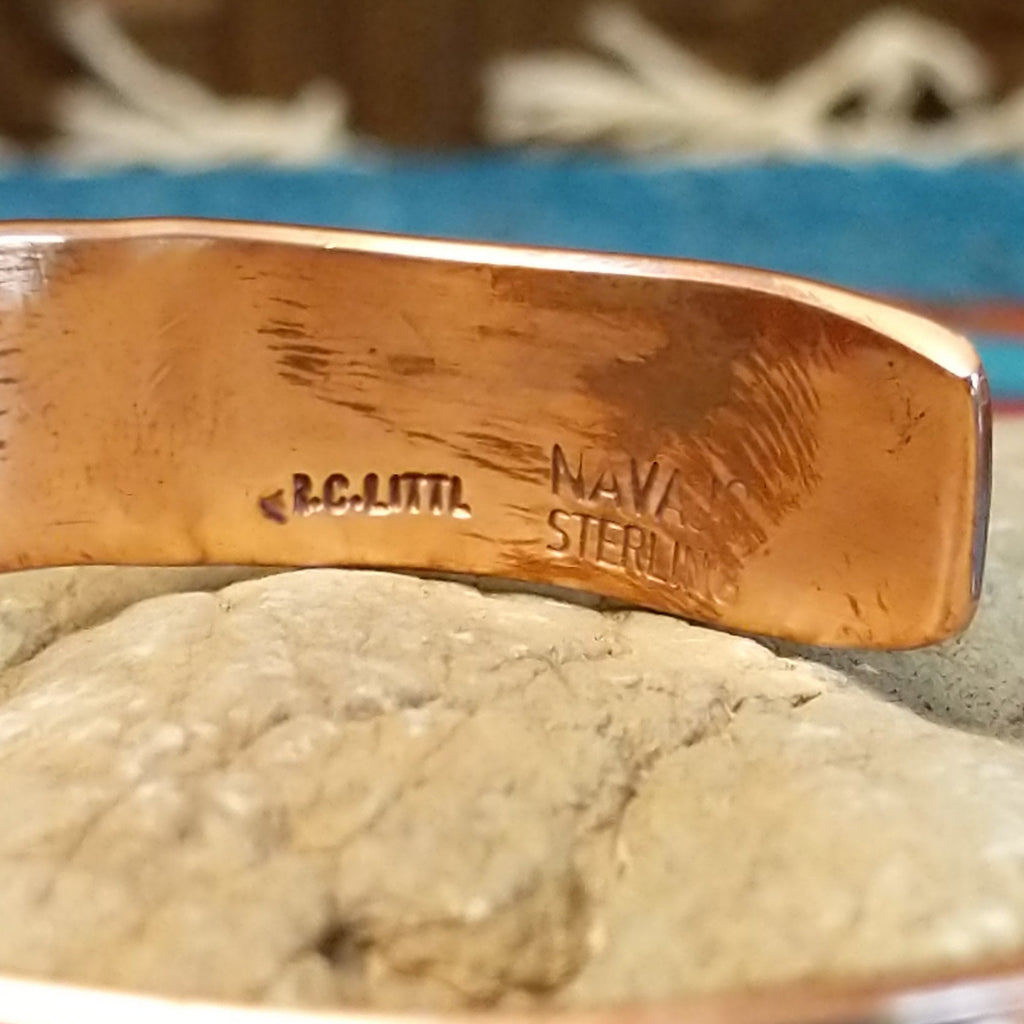 Close-up of the artisan's stamped signature.