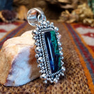 Square sterling silver pendant with azurite set within the bezel, twisted rope accents, and dotted detailing.