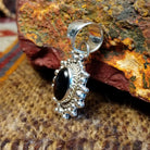 Sterling silver and black onyx pendant framed by dotted accents and a twisted rope design.
