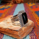 Dotted Black Onyx Ring by Alvin Joe featuring a large polished rectangular black onyx stone framed by twisted silver rope and a border of raised silver beads; side view.