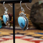 Sterling silver Golden Hills turquoise dangle earrings featuring teardrop-shaped stones, rope detailing, and silver bead accents.