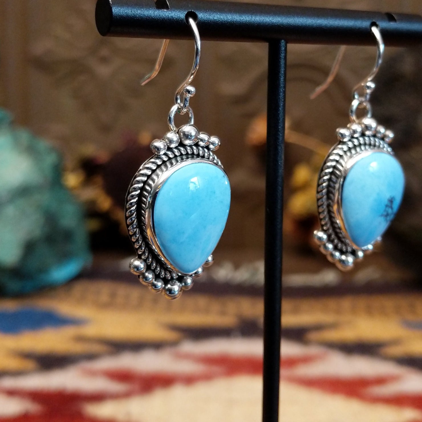 Sterling silver Golden Hills turquoise dangle earrings featuring teardrop-shaped stones, rope detailing, and silver bead accents.