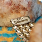 Close-up of the artisan's stamped signature.