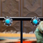 Sterling silver earrings with Kingman turquoise set in round bezels, framed by twisted rope and dotted accents.