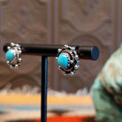 Sterling silver earrings with Kingman turquoise set in round bezels, framed by twisted rope and dotted accents.