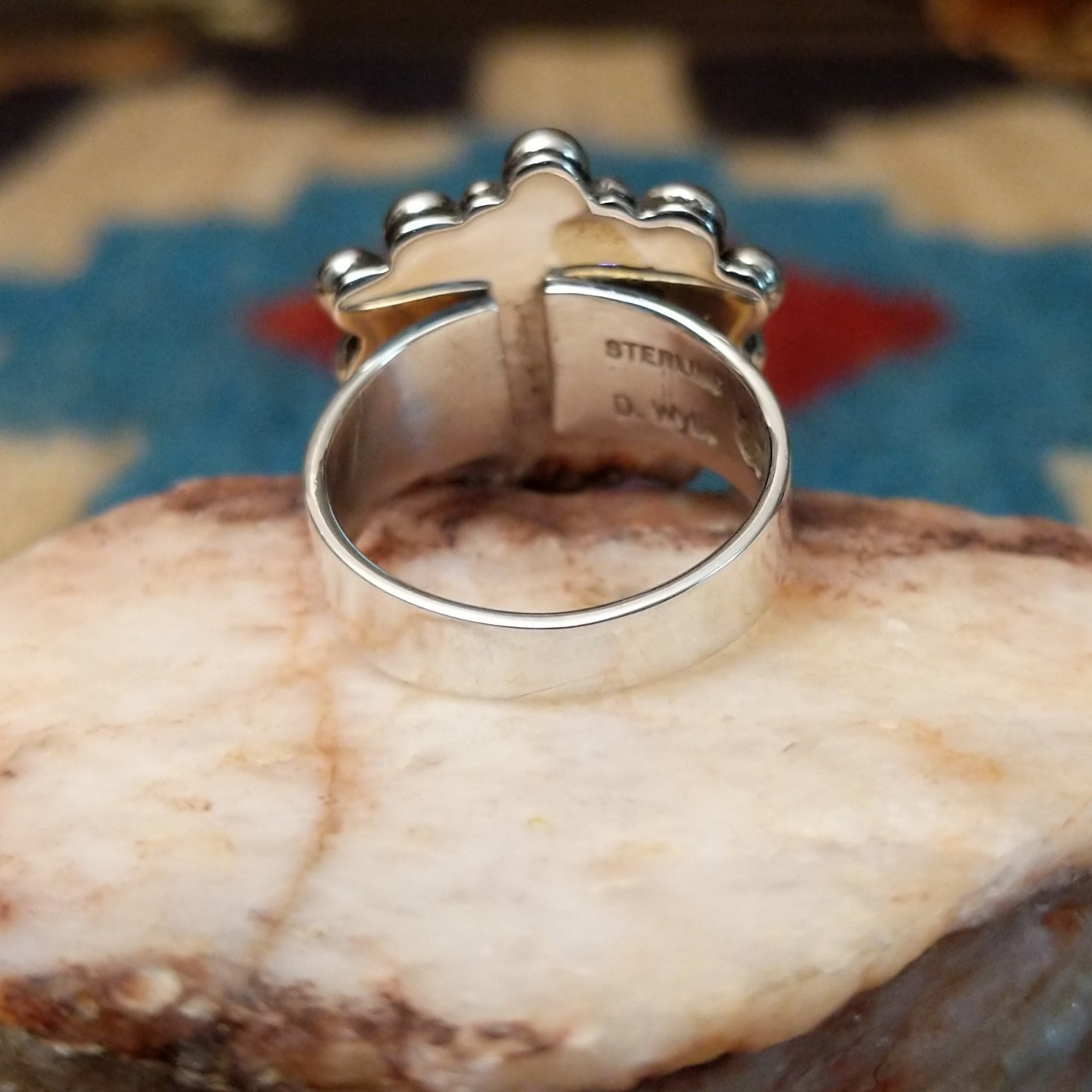 Sterling silver ring with lapis set in the round bezel, framed by dotted accents.