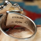 Close-up of the artisan's stamped signature.