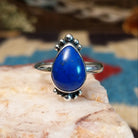 Sterling silver ring with lapis set in the teardrop bezel, framed by dotted accents.