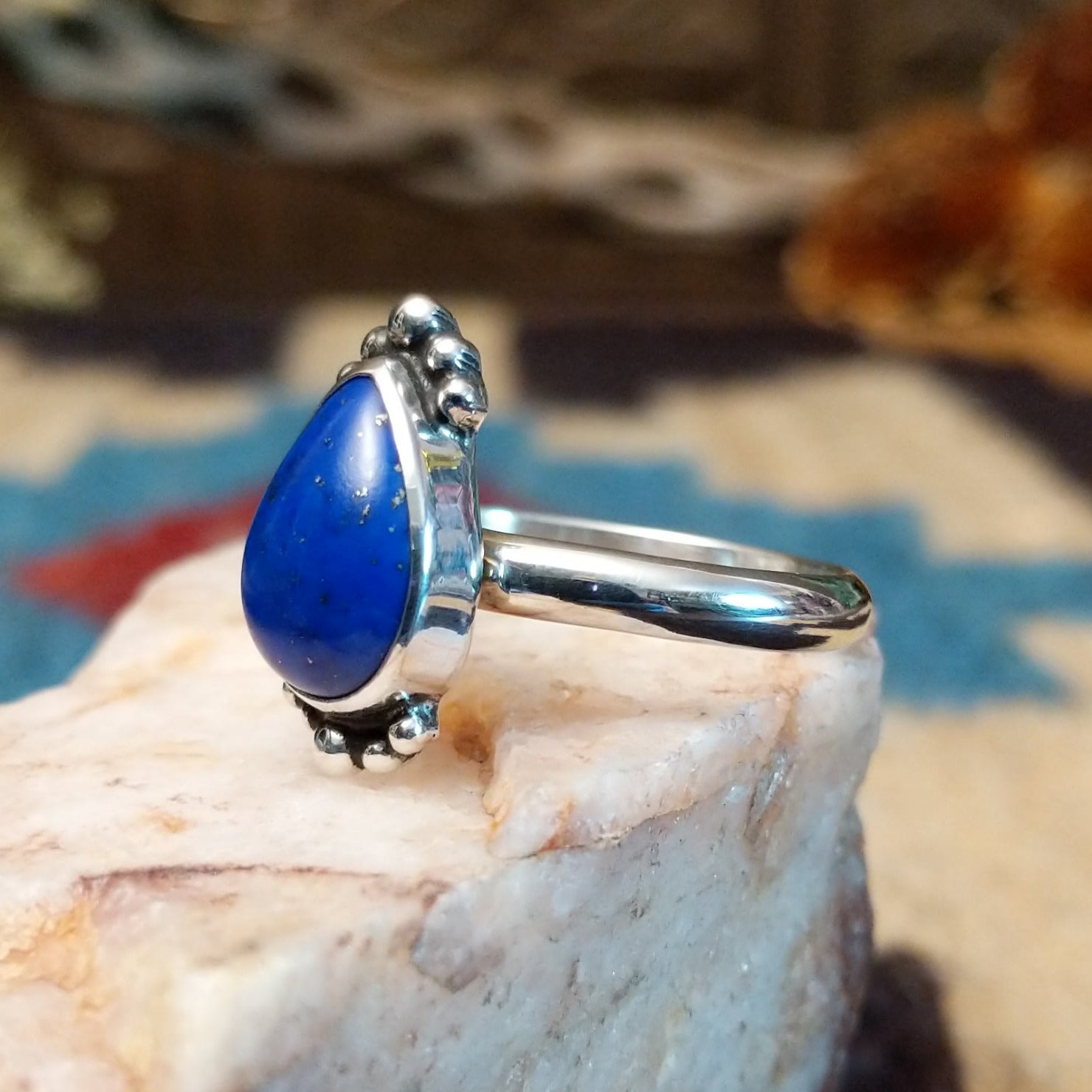 Sterling silver ring with lapis set in the teardrop bezel, framed by dotted accents.