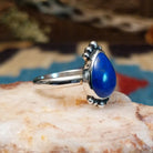 Sterling silver ring with lapis set in the teardrop bezel, framed by dotted accents.
