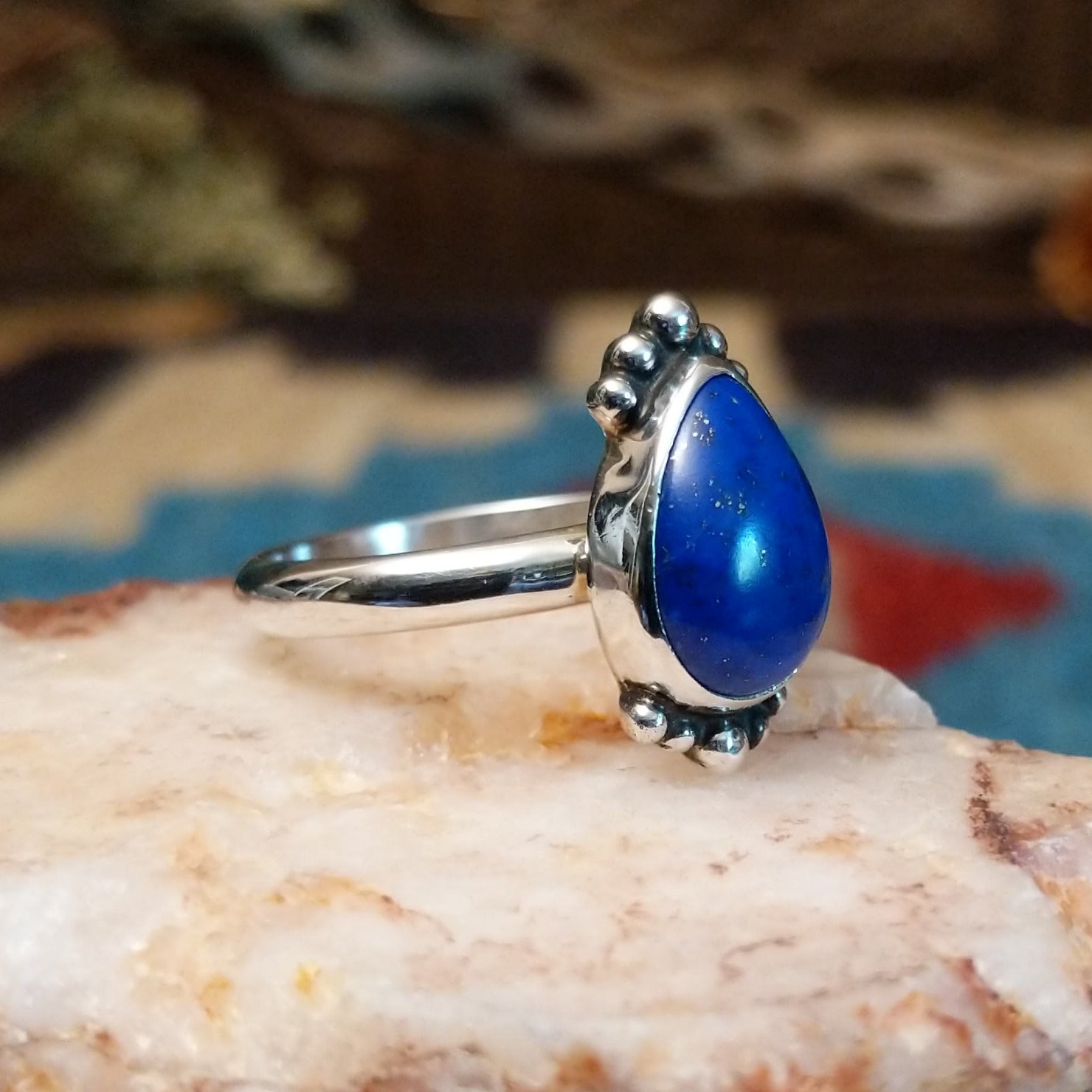 Sterling silver ring with lapis set in the teardrop bezel, framed by dotted accents.
