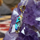 14kt gold Steve Francisco oval multistone pendant with geometric inlay and gold bead accents.