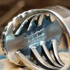 Close-up of the artisan's stamped signature.