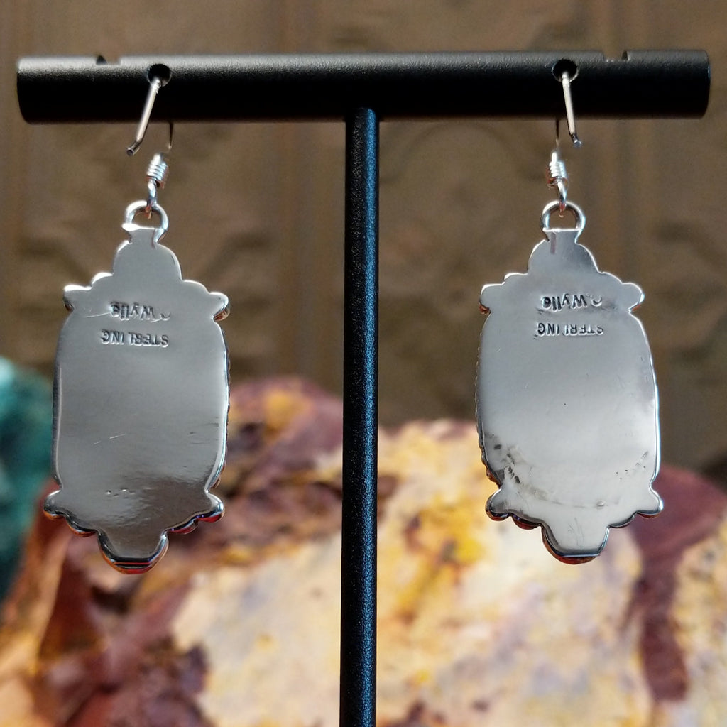 The artisan's signature is stamped onto the back of the earrings.