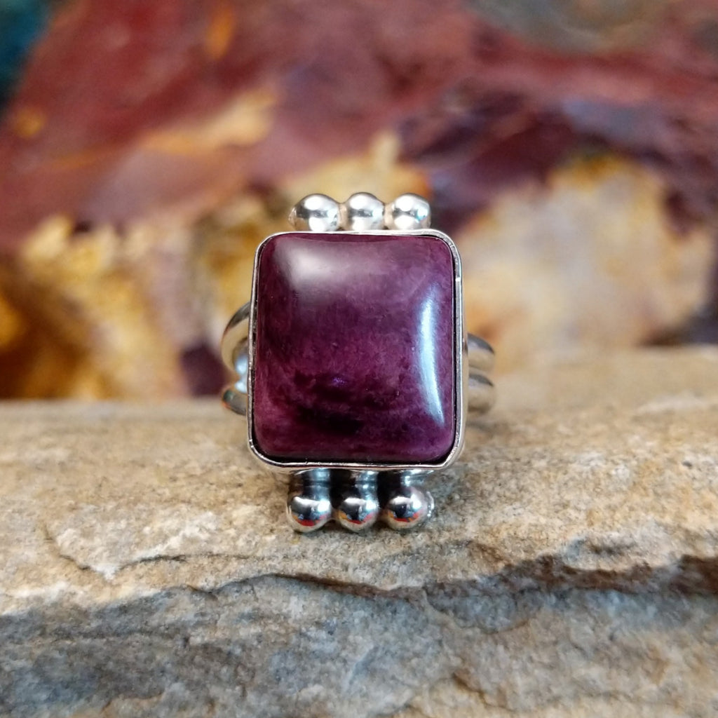 Square purple spiny oyster shell set in a sterling silver bezel with dotted accents.
