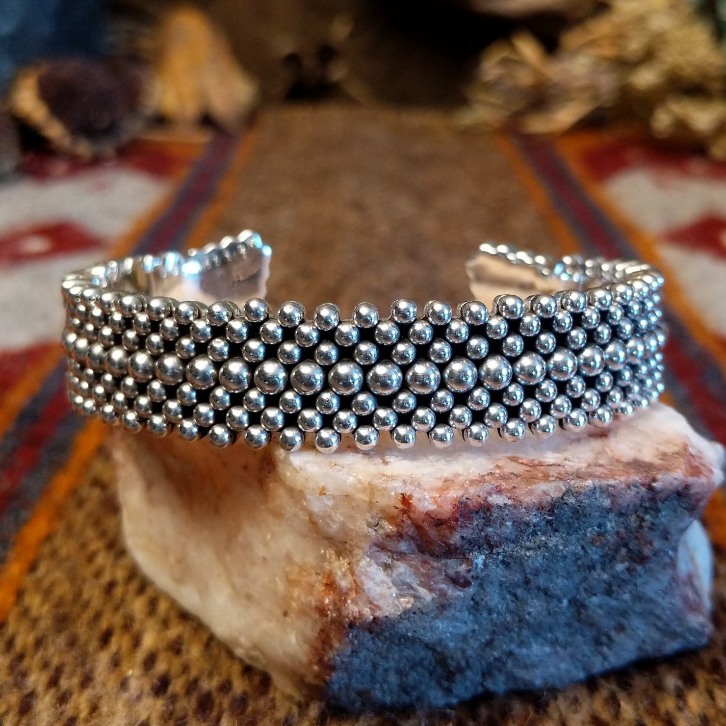 Intricately dotted sterling silver cuff bracelet.
