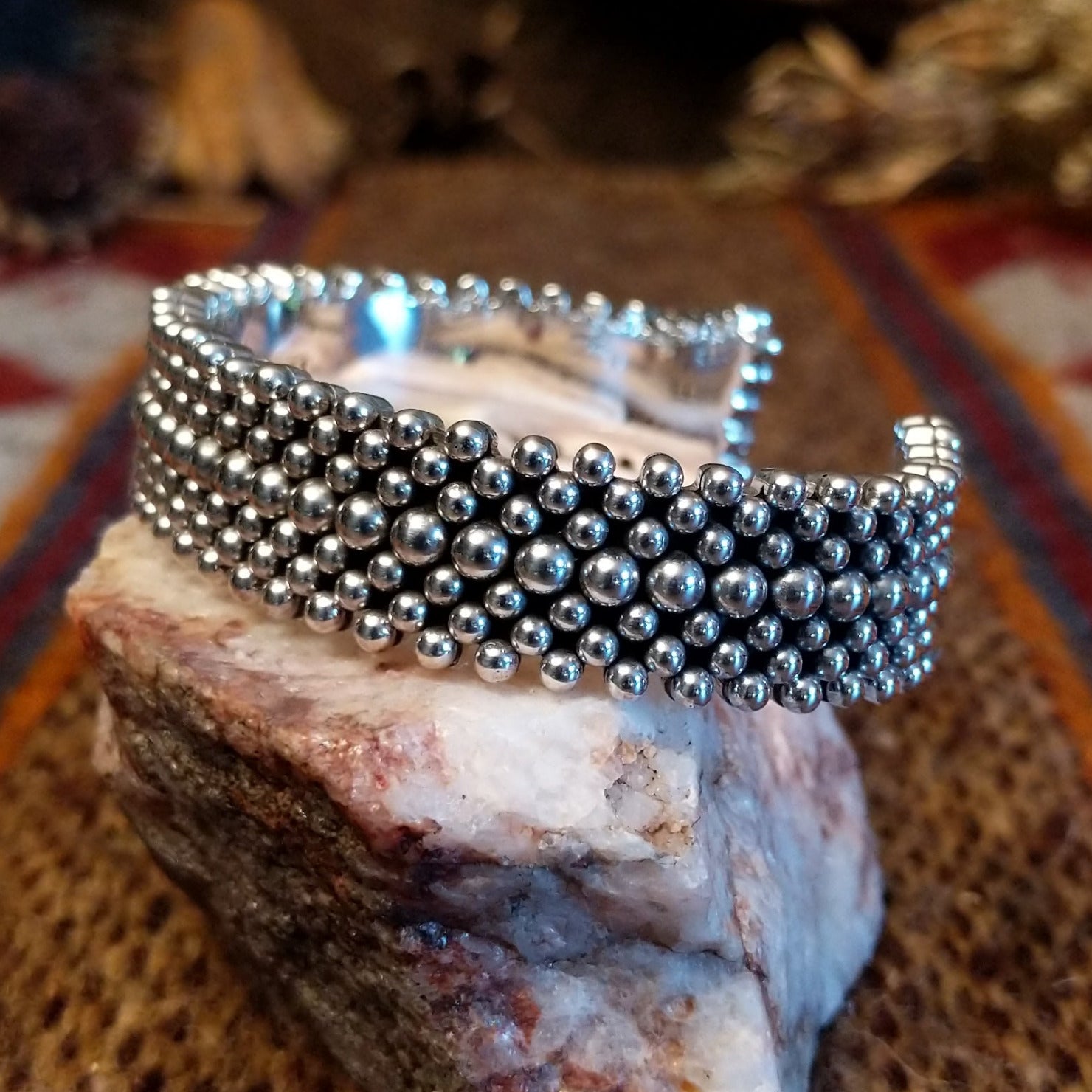 Intricately dotted sterling silver cuff bracelet.