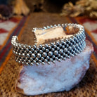 Intricately dotted sterling silver cuff bracelet.
