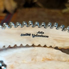 Close-up of the artisan's stamped signature.