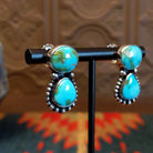 Earrings with Sonoran Mountain turquoise set in bezels, framed by dotted accents. 