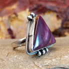 Triangular purple spiny oyster shell with twisted rope accent and dotted embellishments.