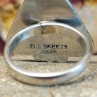 The artisan's stamp found on the underside of the bezel.