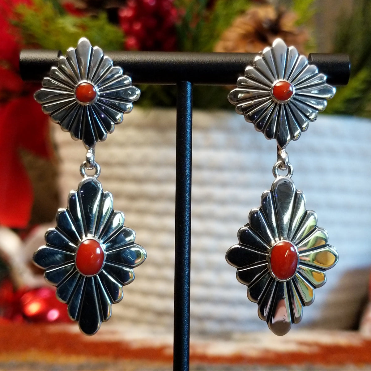 Double diamond setting earrings with red coral set in the bezels as the centerpiece.