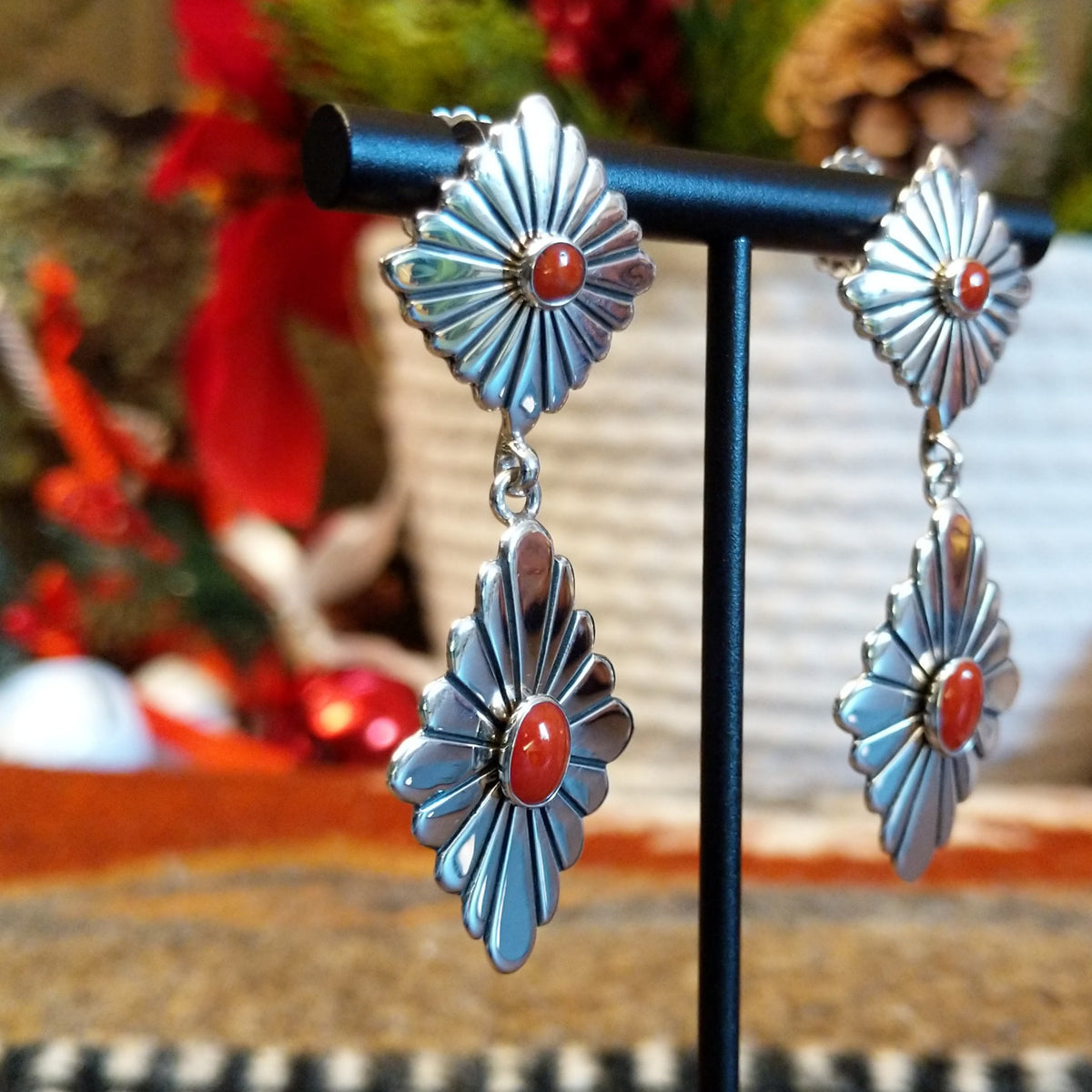 Double diamond setting earrings with red coral set in the bezels as the centerpiece.