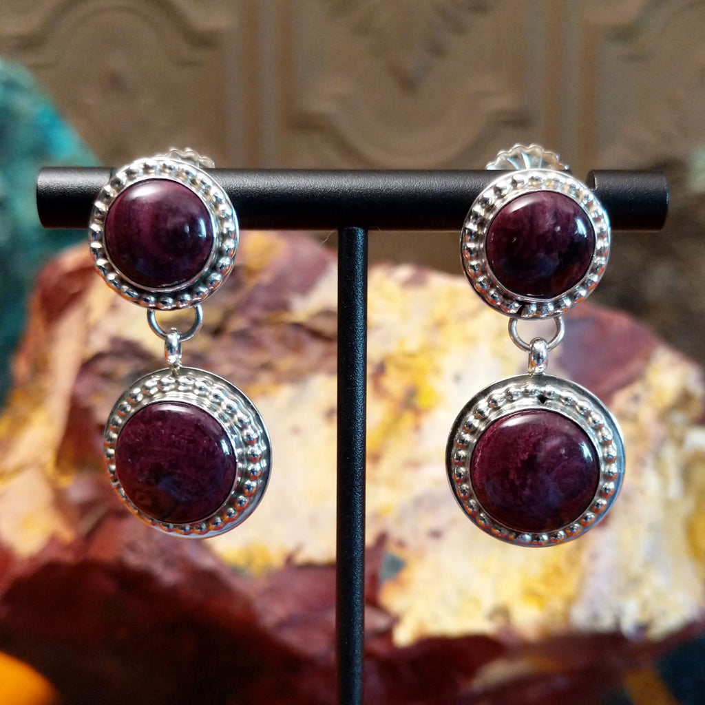 Purple spiny oyster shell set in a smooth bezel with intricate dotting along the frame.