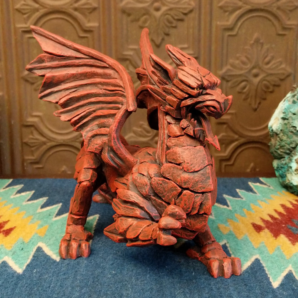 Cast marble made into a dragon sculpture and painted reddish-orange.