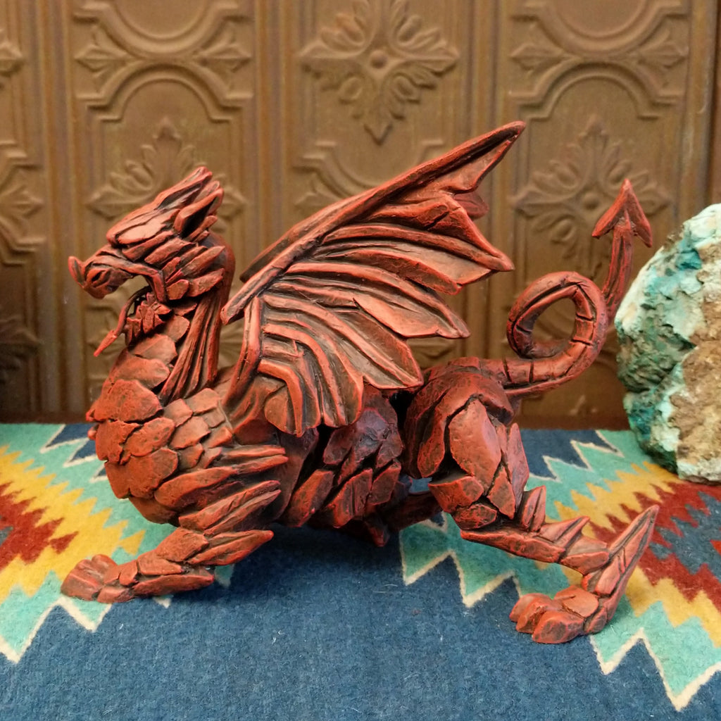 Cast marble made into a dragon sculpture and painted reddish-orange.