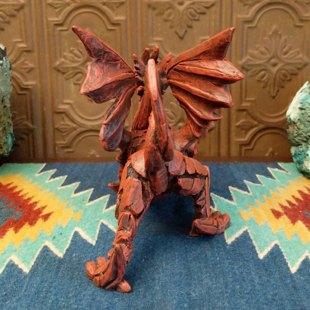 Cast marble made into a dragon sculpture and painted reddish-orange.