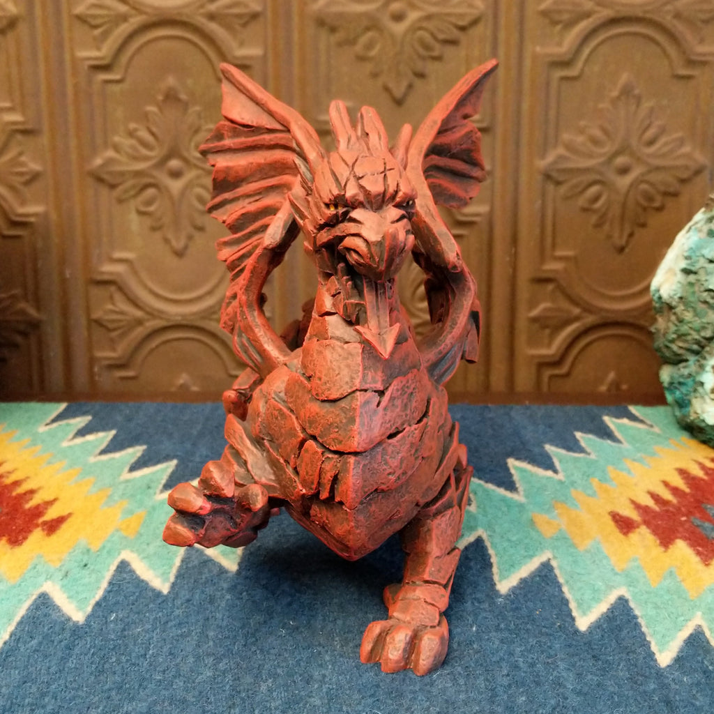 Cast marble made into a dragon sculpture and painted reddish-orange.