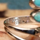 Close-up of the artist's stamped signature.