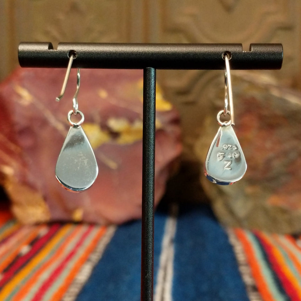 The back of the sterling silver bezels showcase the authentication stamp.