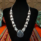 Artisan's signature stamped into the largest necklace pendant.