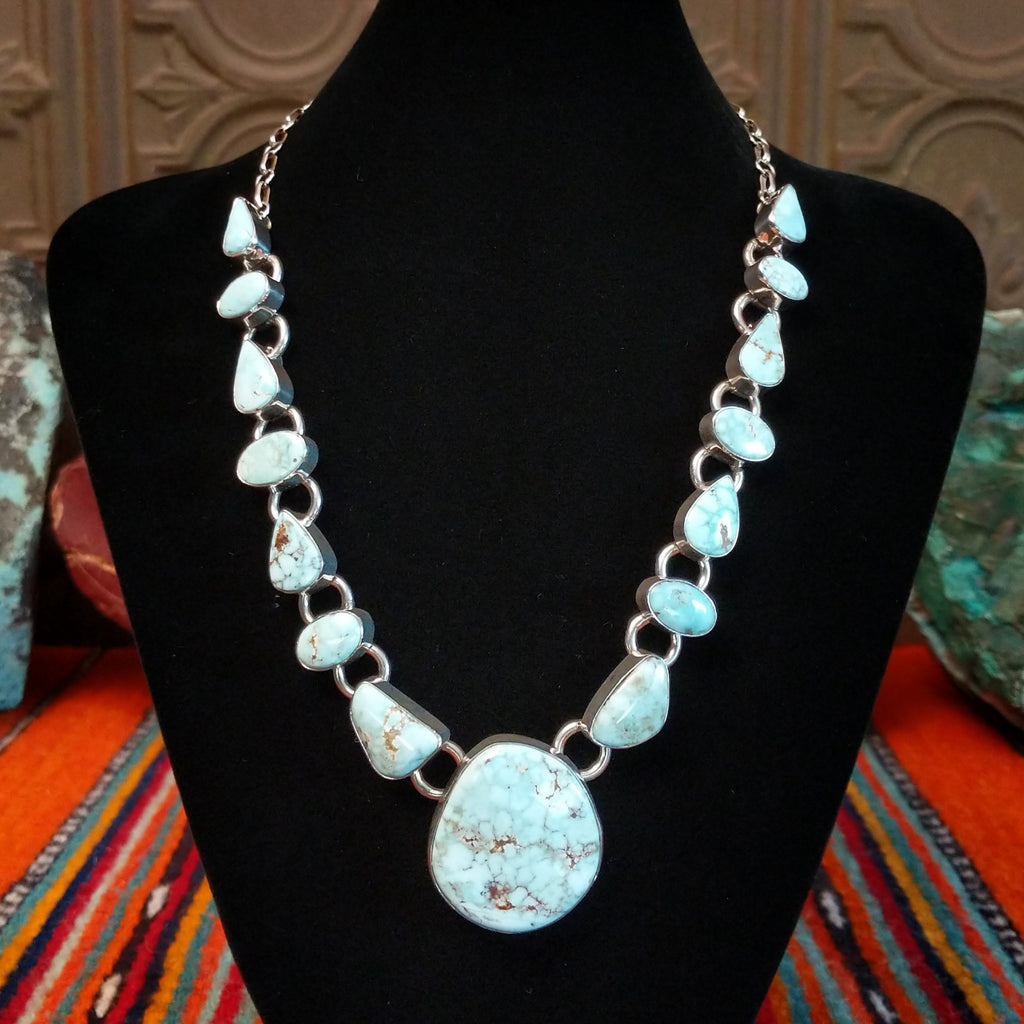 Dry Creek turquoise set in sterling silver bezels that make up the chained necklace and earrings.
