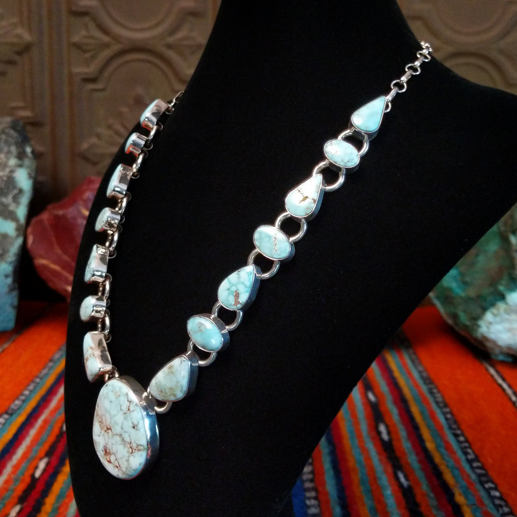 Dry Creek turquoise set in sterling silver bezels that make up the chained necklace and earrings.