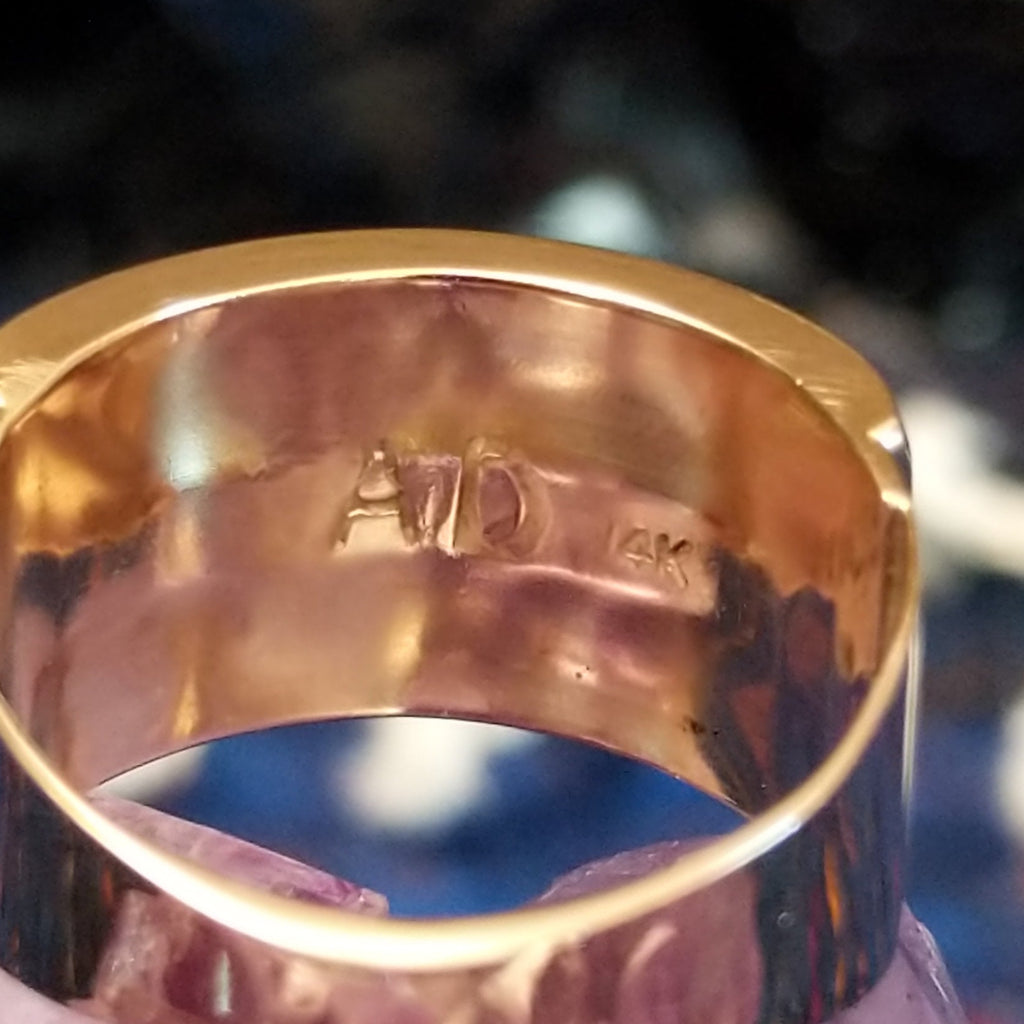 The artist's stamp inside the gold ring.