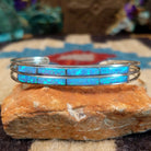 Dual row manmade opal inlay cuff by Jamie Johnson, featuring shimmering opal inlay with vibrant flashes of color set in handcrafted Southwestern-inspired metalwork.