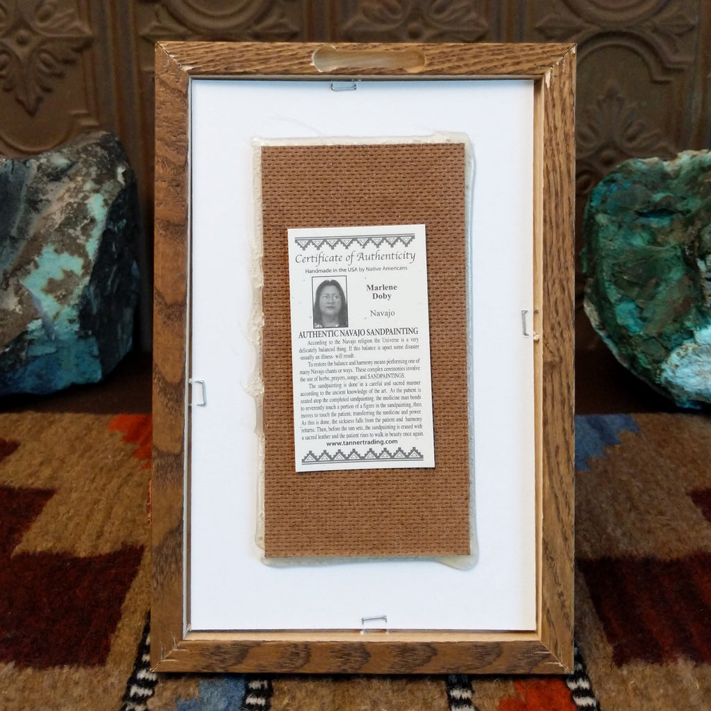 The back features a place to hang the artwork as well as the artisan's info.