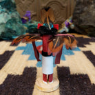 Mini eagle kachina by Rosalind Grey with turquoise face, black fur collar, feathered crest, and outstretched arms.