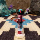 Mini eagle kachina by Rosalind Grey with turquoise face, black fur collar, feathered crest, and outstretched arms.